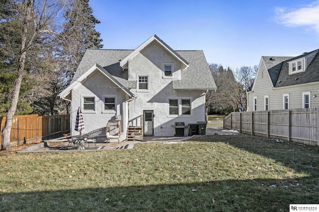 back of house with a patio area and a lawn