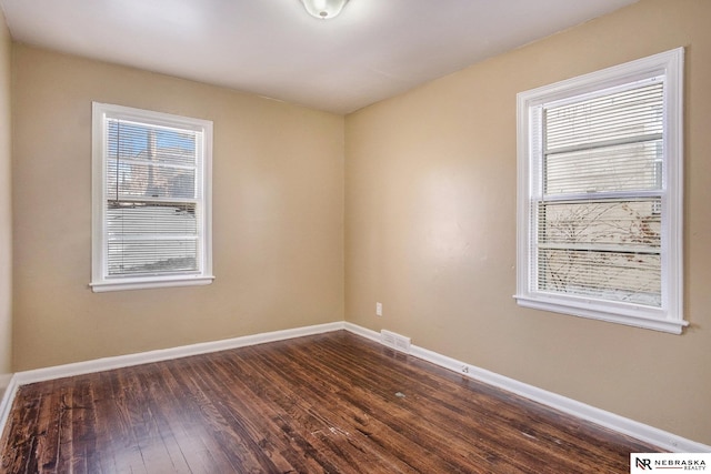 unfurnished room with dark hardwood / wood-style floors