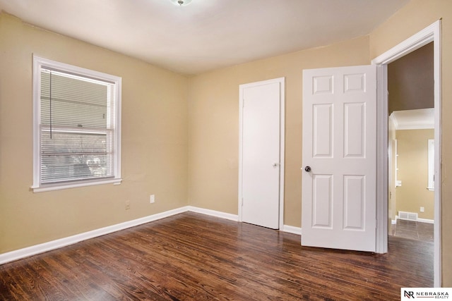 unfurnished bedroom featuring dark wood-type flooring