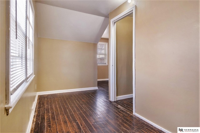 interior space featuring dark hardwood / wood-style flooring and lofted ceiling