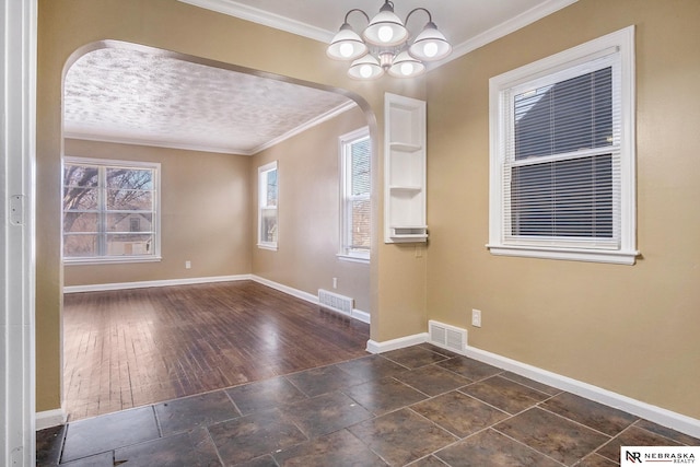 interior space with ornamental molding and a chandelier