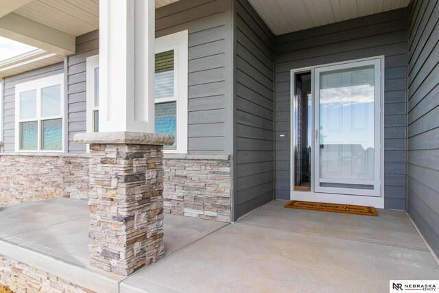 doorway to property with a porch