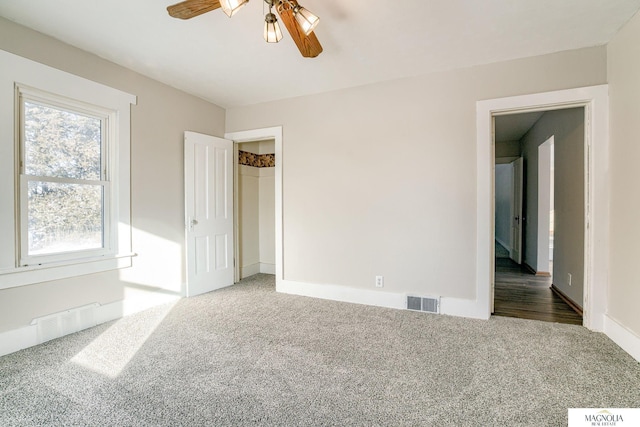 carpeted empty room featuring ceiling fan