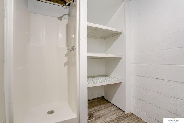 bathroom featuring hardwood / wood-style floors and walk in shower