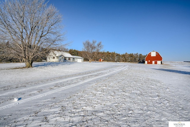 yard layered in snow featuring an outbuilding