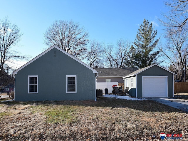 view of home's exterior with an outbuilding, a yard, and a garage