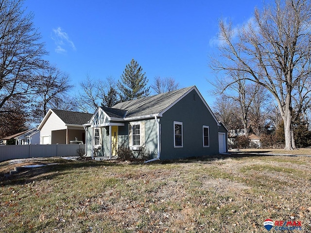 single story home with a garage and a front lawn