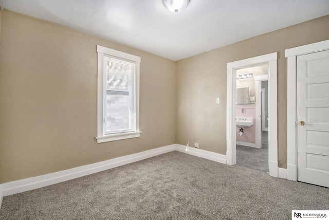 unfurnished bedroom with carpet and sink