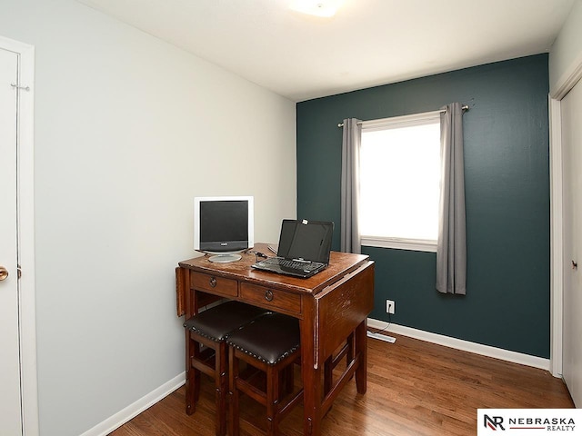 home office with hardwood / wood-style floors