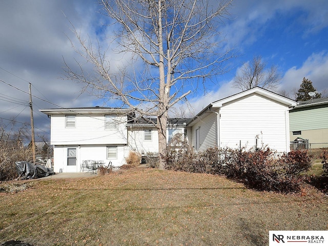 rear view of house with a yard