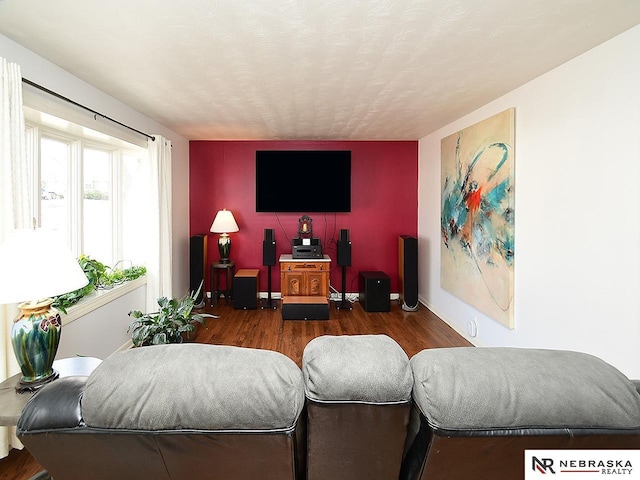 living room featuring a textured ceiling and dark wood-type flooring