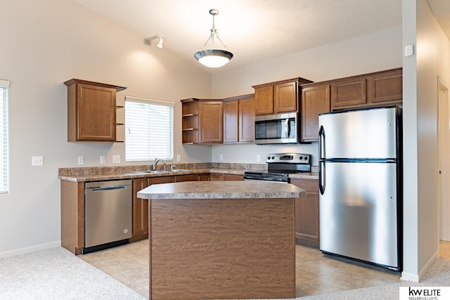 kitchen featuring stainless steel appliances, vaulted ceiling, light colored carpet, sink, and pendant lighting