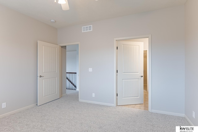 unfurnished bedroom featuring ceiling fan and light colored carpet