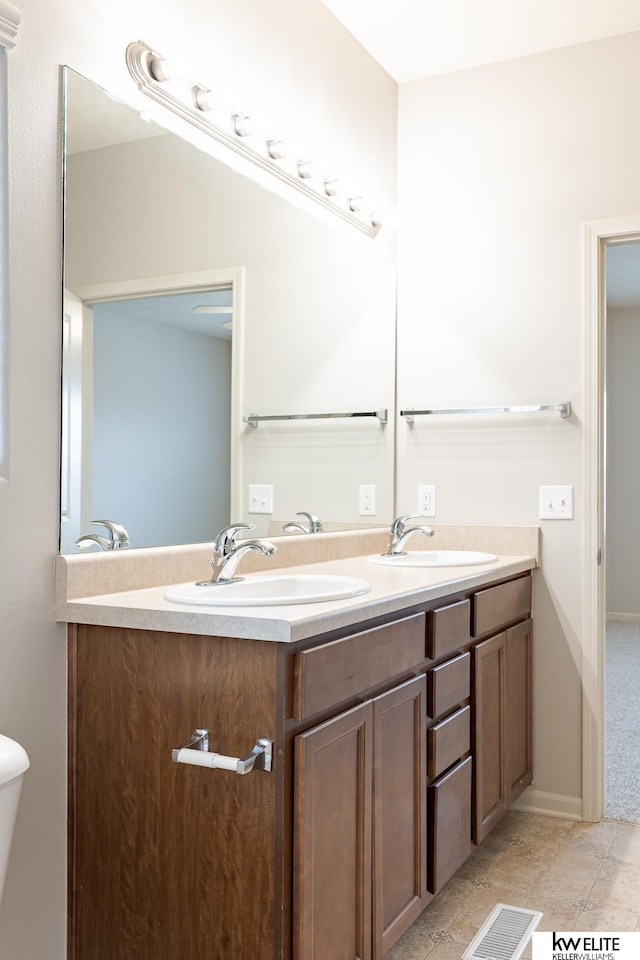 bathroom with vanity and toilet