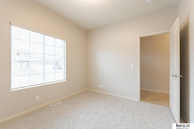 empty room featuring light colored carpet