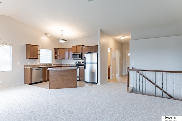 kitchen with stainless steel appliances, light colored carpet, a center island, hanging light fixtures, and lofted ceiling