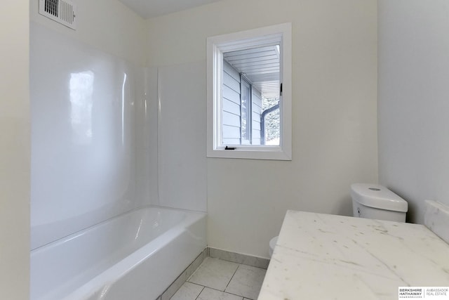 bathroom featuring shower / bathtub combination, tile patterned flooring, and toilet