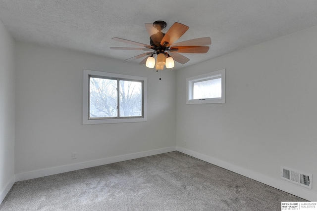 empty room with ceiling fan and carpet flooring