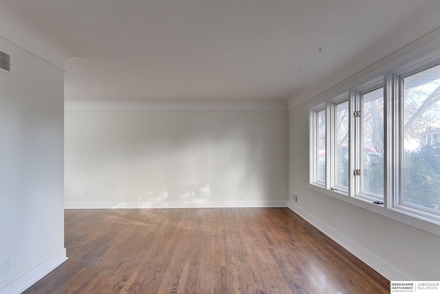 empty room with dark wood-type flooring