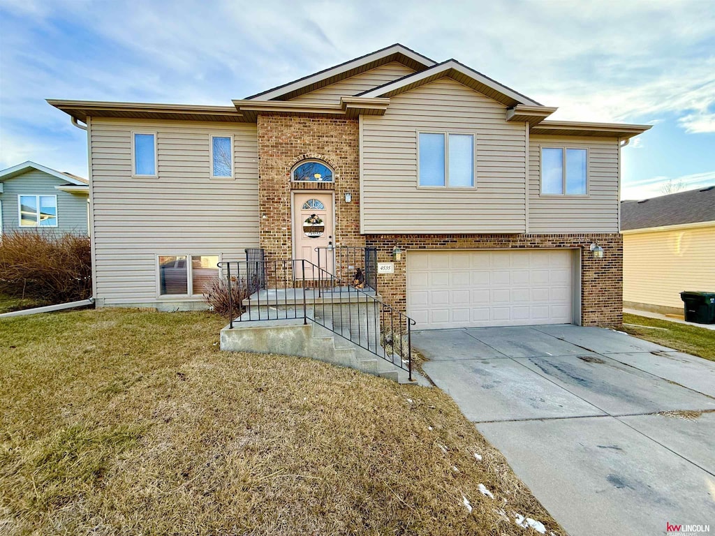 view of front of property with a front yard and a garage