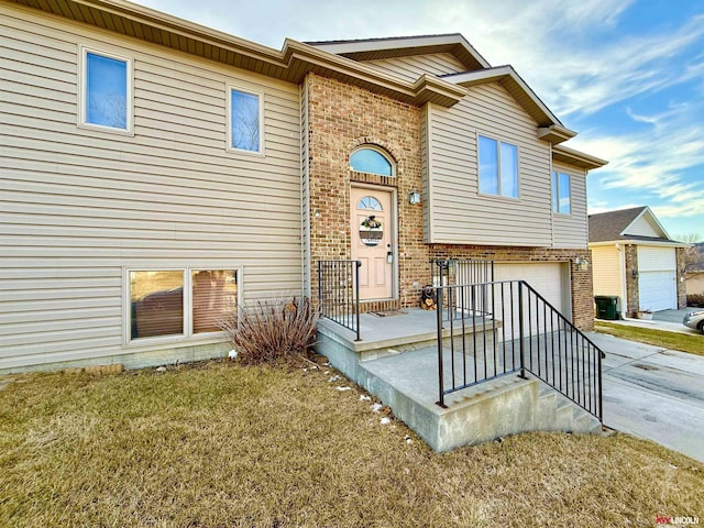 view of front of home with a front yard and a garage