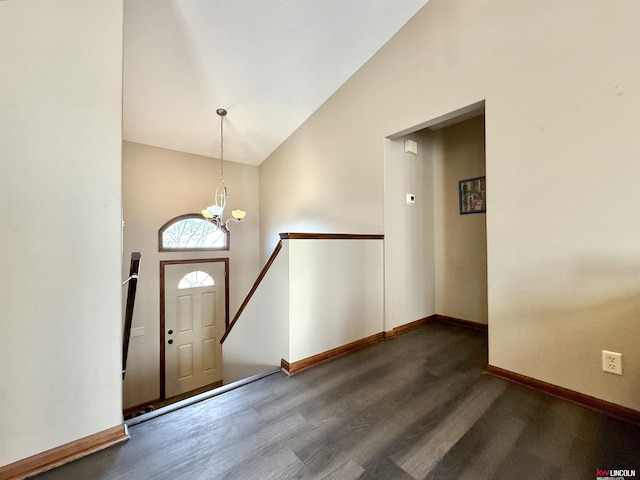 foyer entrance featuring high vaulted ceiling, dark hardwood / wood-style flooring, and a notable chandelier