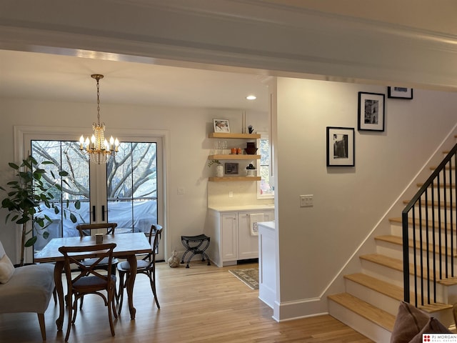 dining area with a notable chandelier and light wood-type flooring