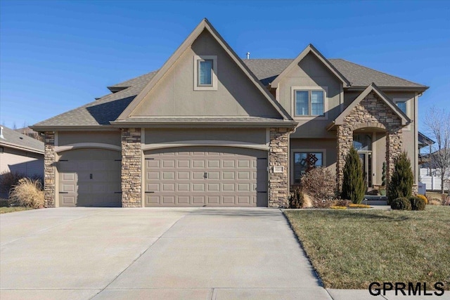 view of front of home featuring a garage and a front yard