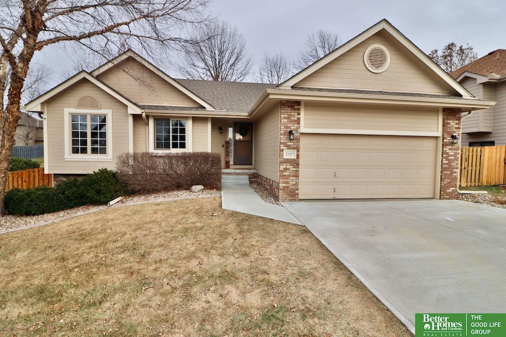 ranch-style house with a garage and a front yard