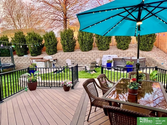 wooden deck featuring a lawn