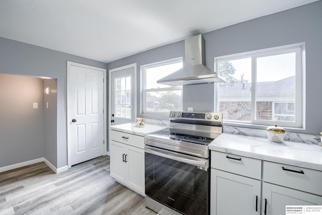 kitchen with white cabinetry, extractor fan, a wealth of natural light, and stainless steel electric range