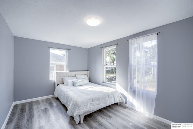 bedroom featuring a textured ceiling and hardwood / wood-style flooring