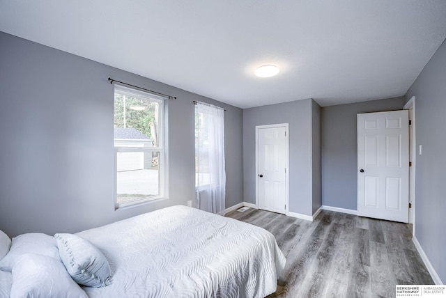 bedroom with hardwood / wood-style flooring