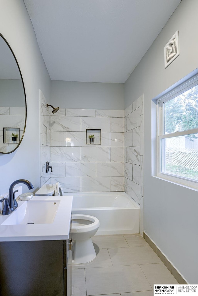 full bathroom with tile patterned flooring, toilet, vanity, and tiled shower / bath