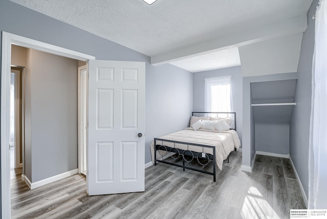 bedroom featuring wood-type flooring and a textured ceiling