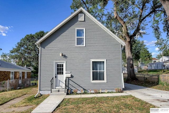 rear view of house with a lawn