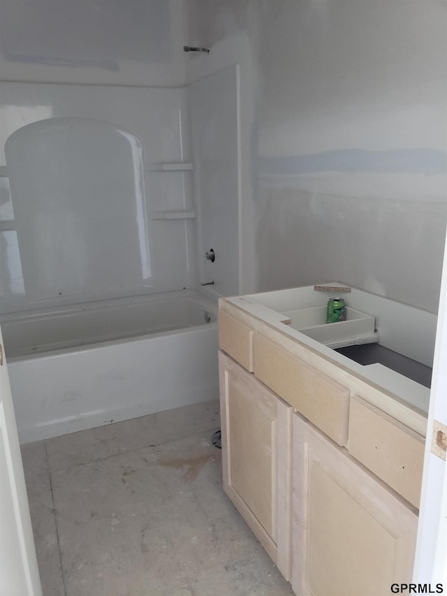 bathroom featuring vanity, shower / bathing tub combination, and concrete floors