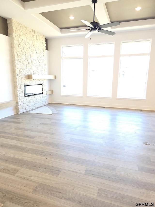 unfurnished living room with recessed lighting, a stone fireplace, wood finished floors, and a ceiling fan