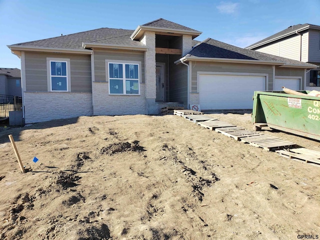 prairie-style home featuring a garage