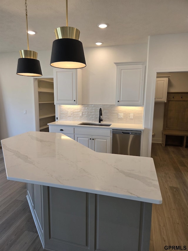 kitchen with dark wood-style floors, white cabinets, dishwasher, and a sink