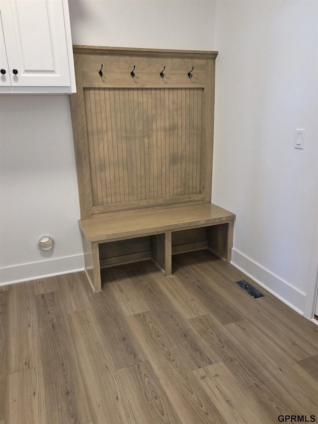 mudroom with visible vents, baseboards, and wood finished floors