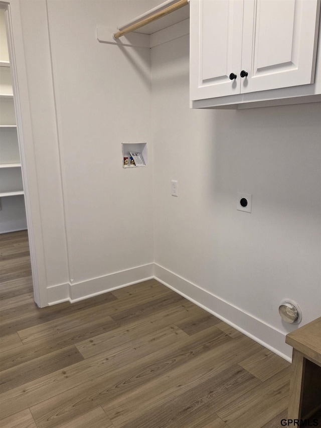 laundry area with wood finished floors, cabinet space, baseboards, hookup for an electric dryer, and hookup for a washing machine