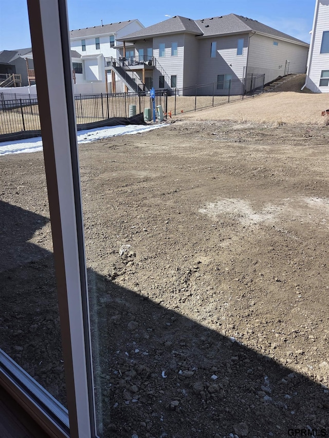 view of yard with a residential view and fence