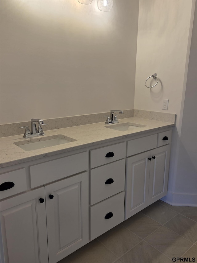 bathroom with a sink, double vanity, and tile patterned floors