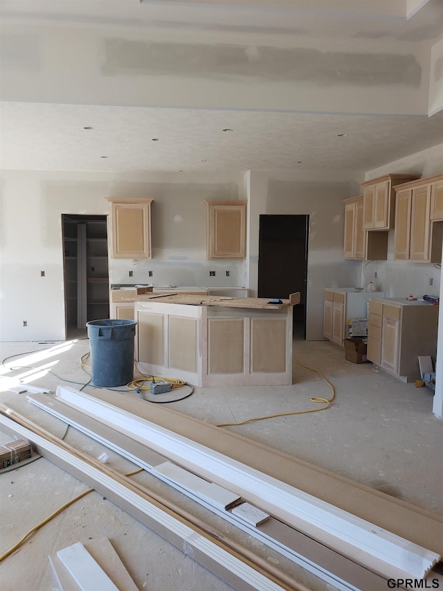 kitchen featuring a center island and light brown cabinets