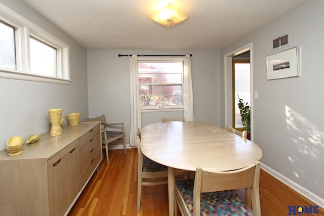 dining space with light hardwood / wood-style flooring