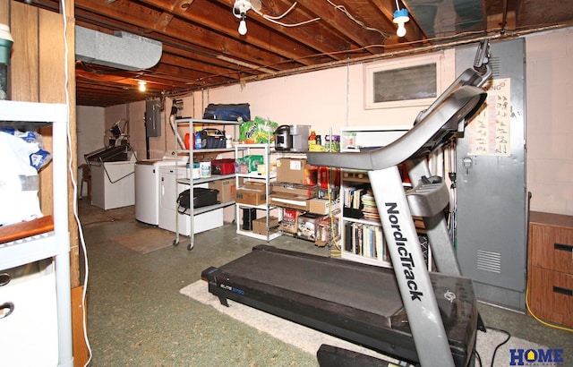 workout area featuring washer and clothes dryer and electric panel