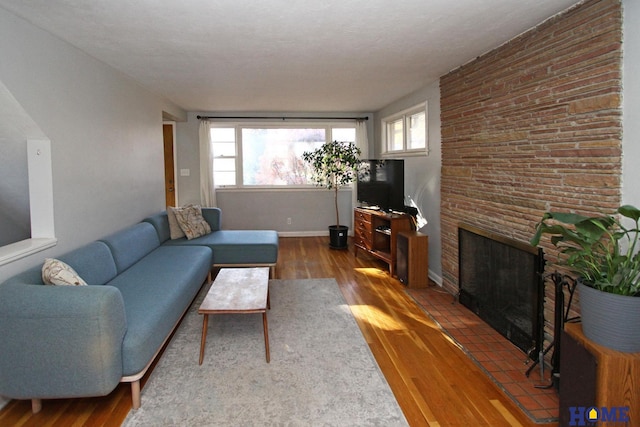 living room with a fireplace, hardwood / wood-style floors, and plenty of natural light