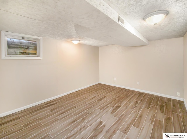 basement featuring a textured ceiling