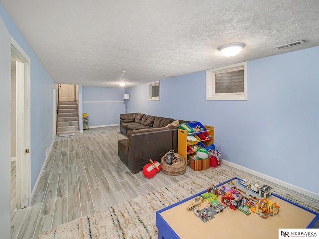 playroom featuring a textured ceiling